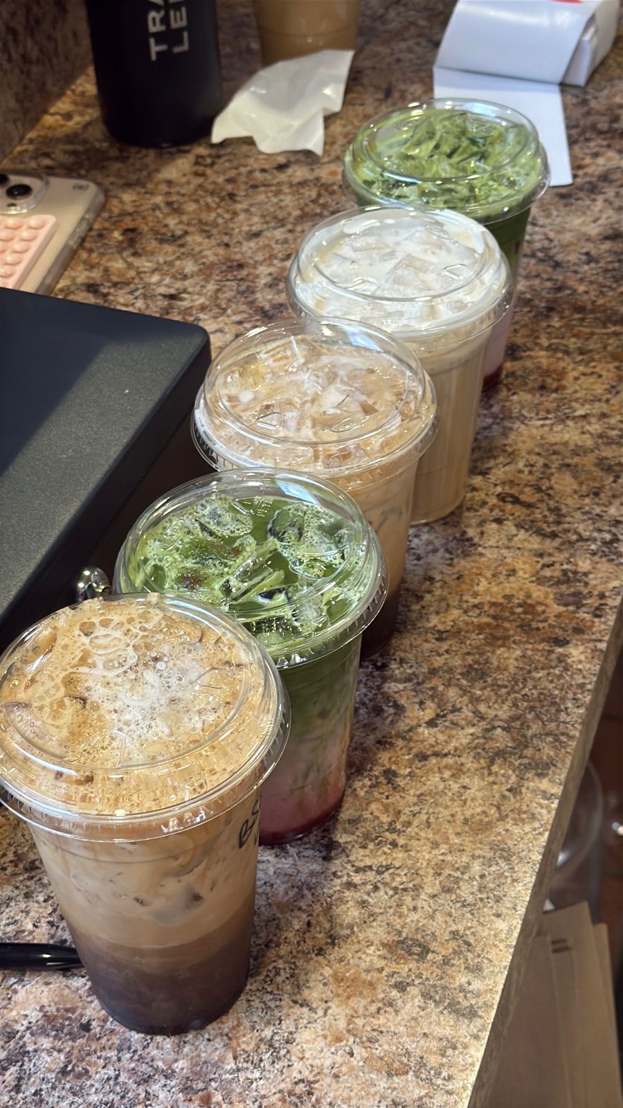 A row of iced drinks lined up on the counter at the TOC bar