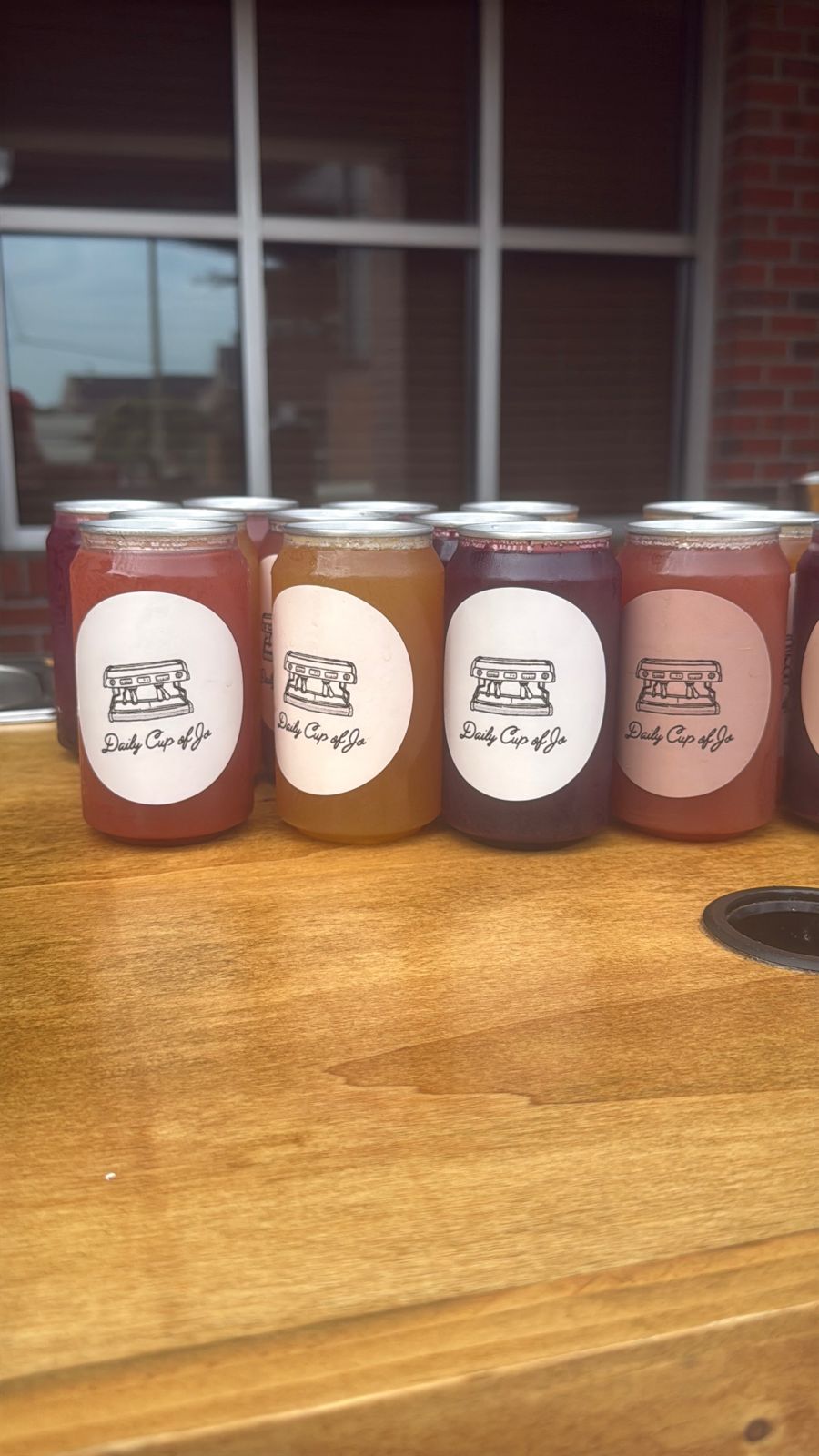 Canned lattes lined up on a wooden counter