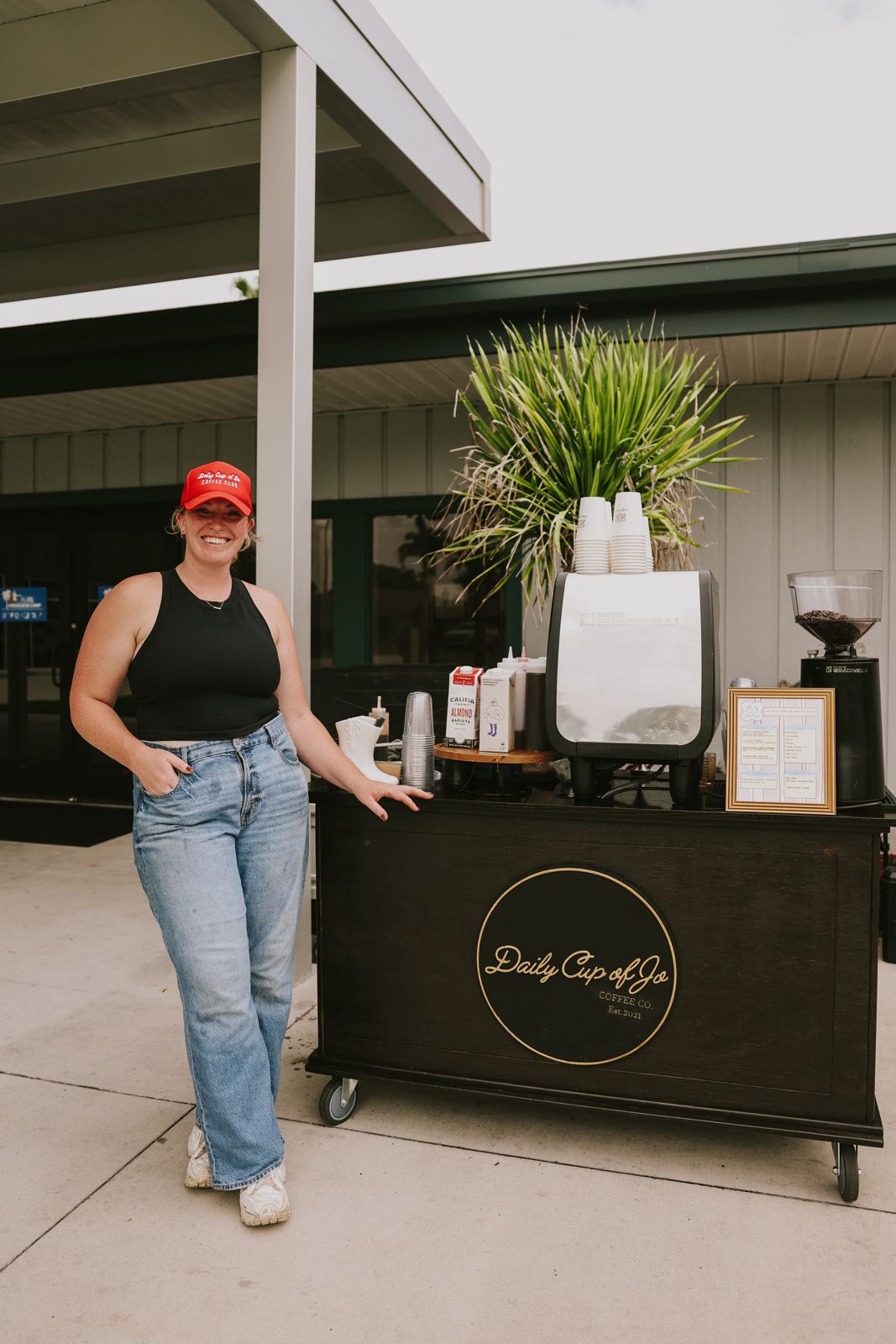 The Daily Cup of Jo mobile coffee cart set up outside an event, barista ready to pour