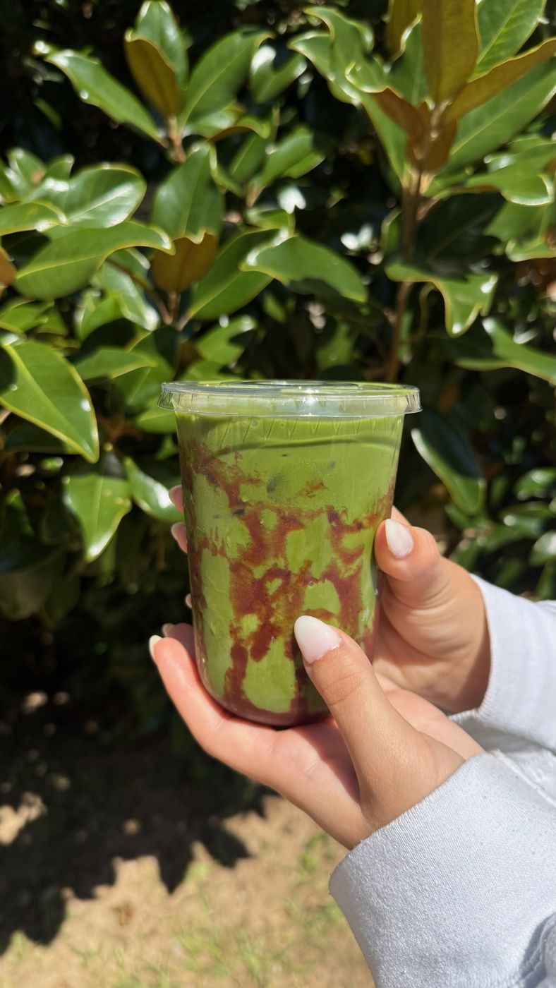An iced Strawberry Matcha with strawberry puree swirled through the matcha