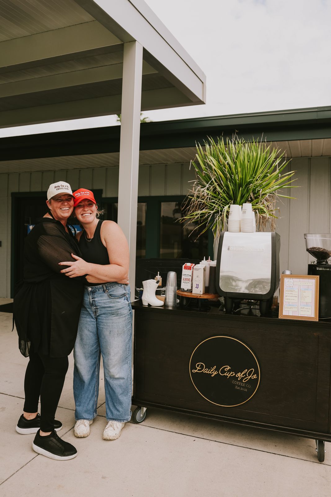 Two friends hugging in front of the cart