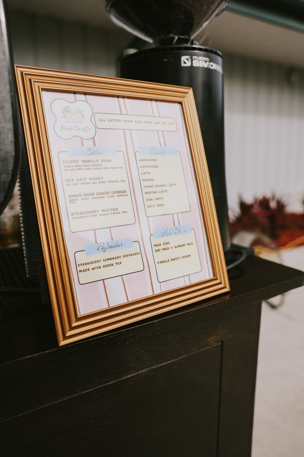 The framed cart menu propped against the grinder